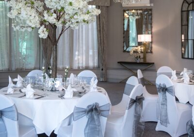 Lycra Chair Covers with Grey Linen Sashes and Blossom Trees