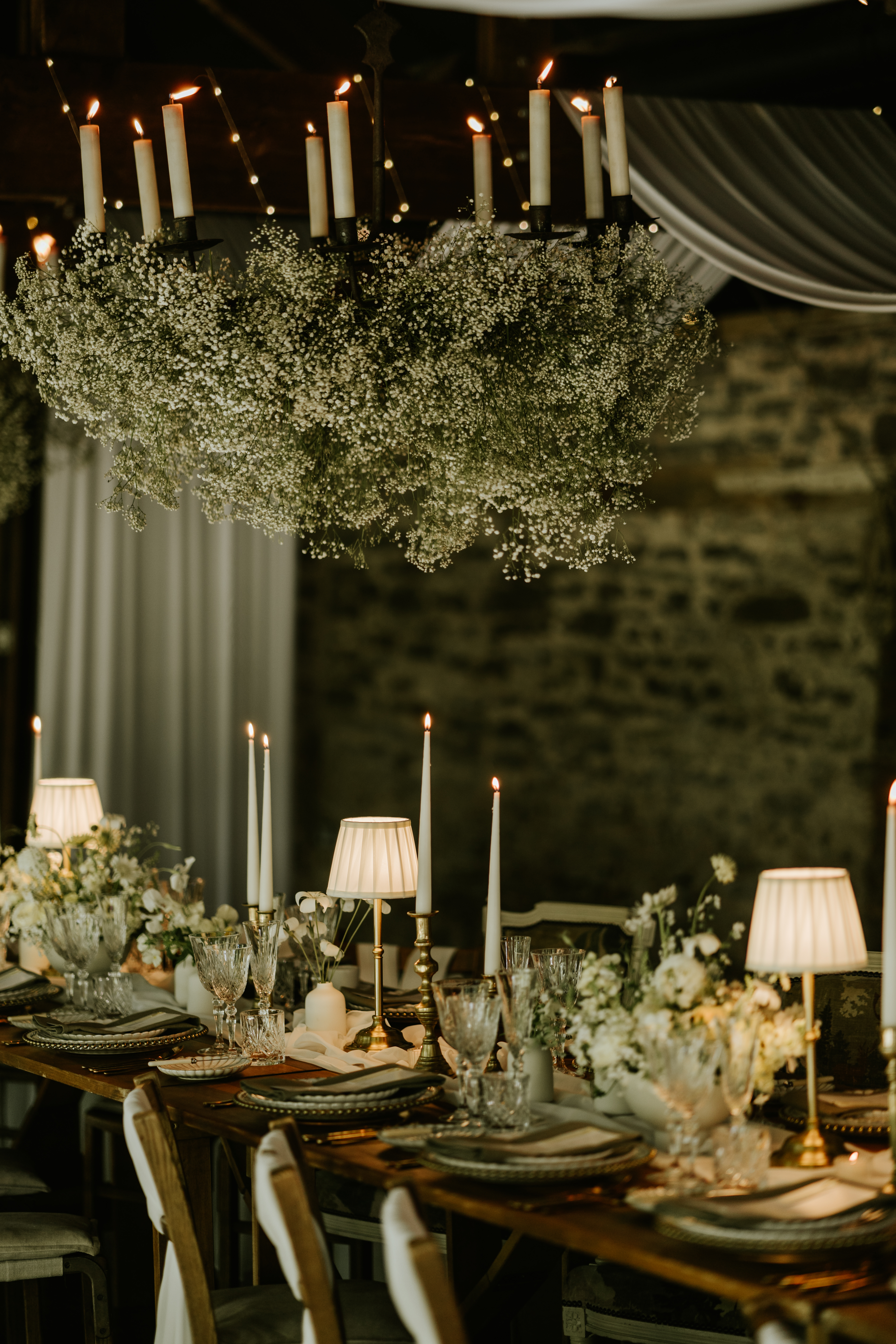 Venue Styling wedding breakfast with lighting and ceiling drapes and floral installation