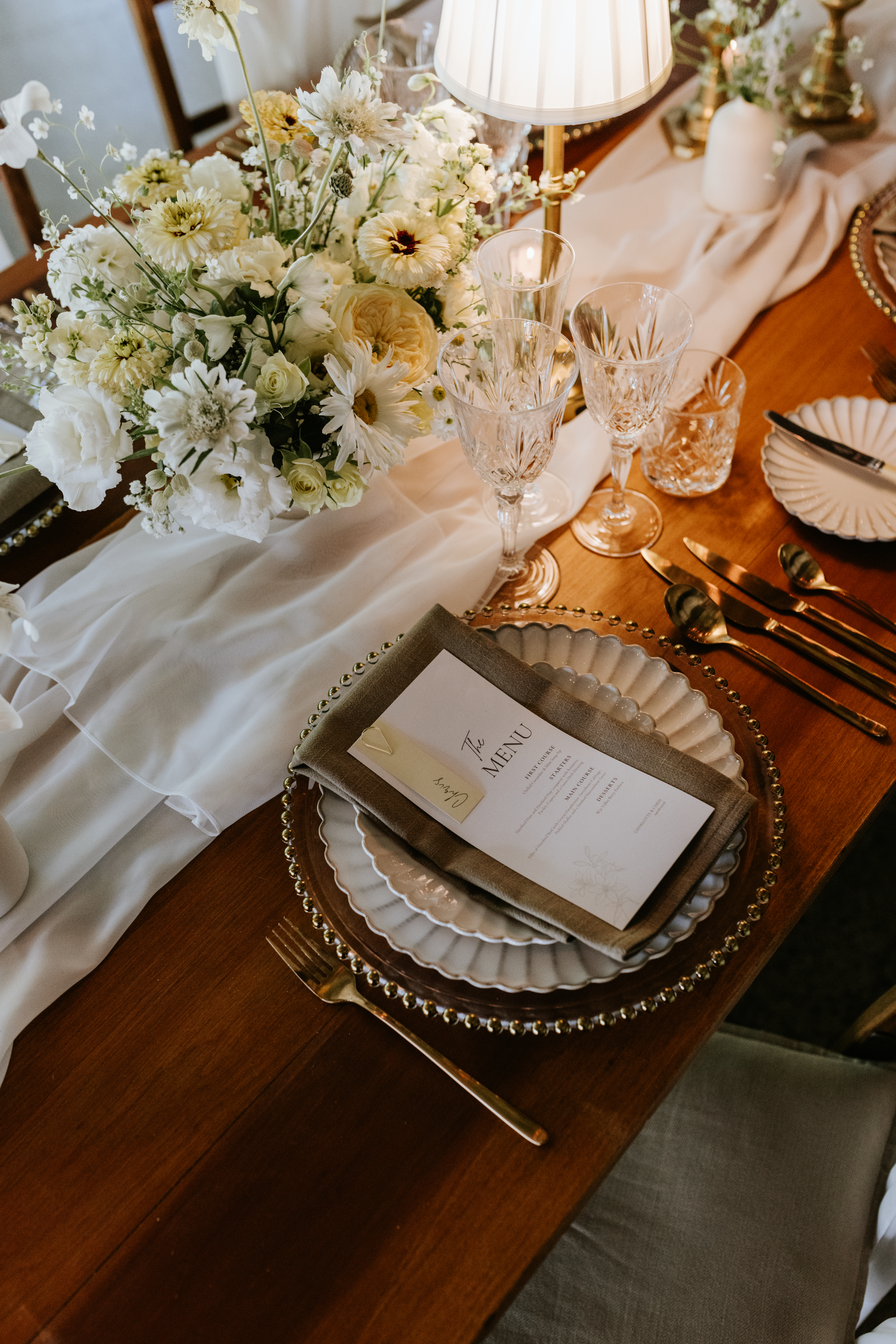 Venue styling bespoke place settings with charger plates coloured napkins and stationery